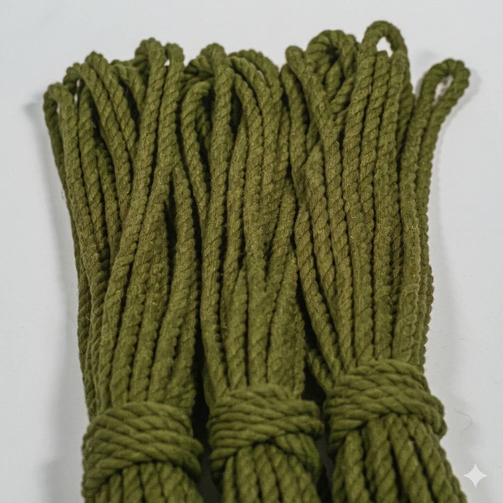Green braided cotton rope on a white background